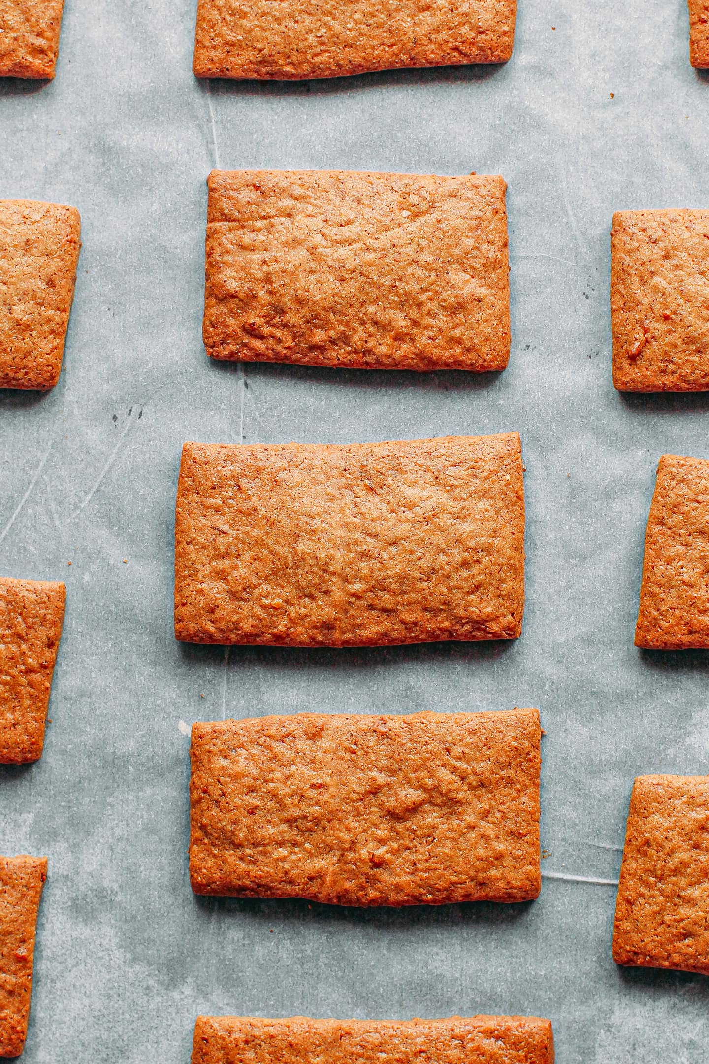 Baked speculoos cookies on a baking sheet.