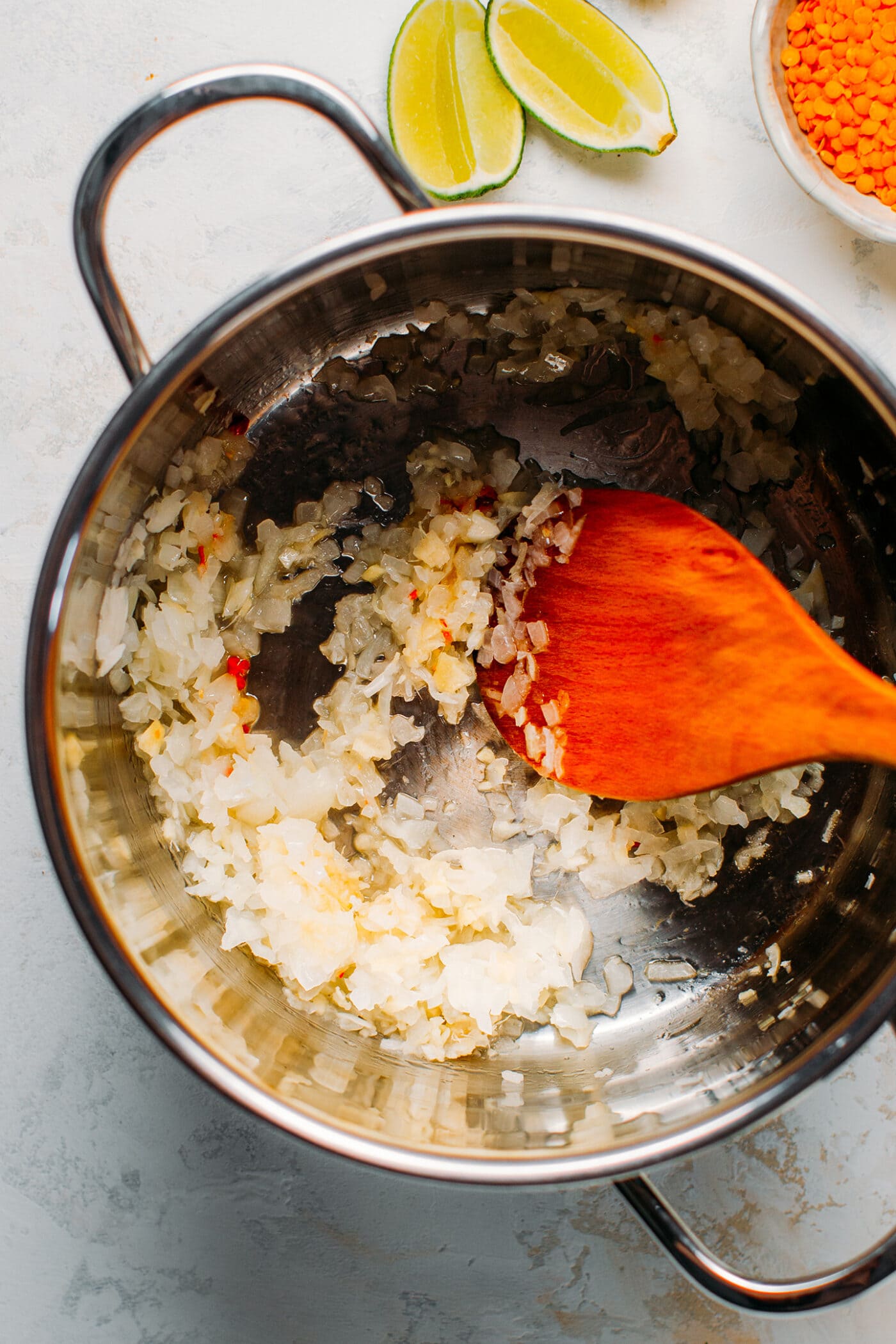 Sautéed onions, garlic, and ginger in a pot.