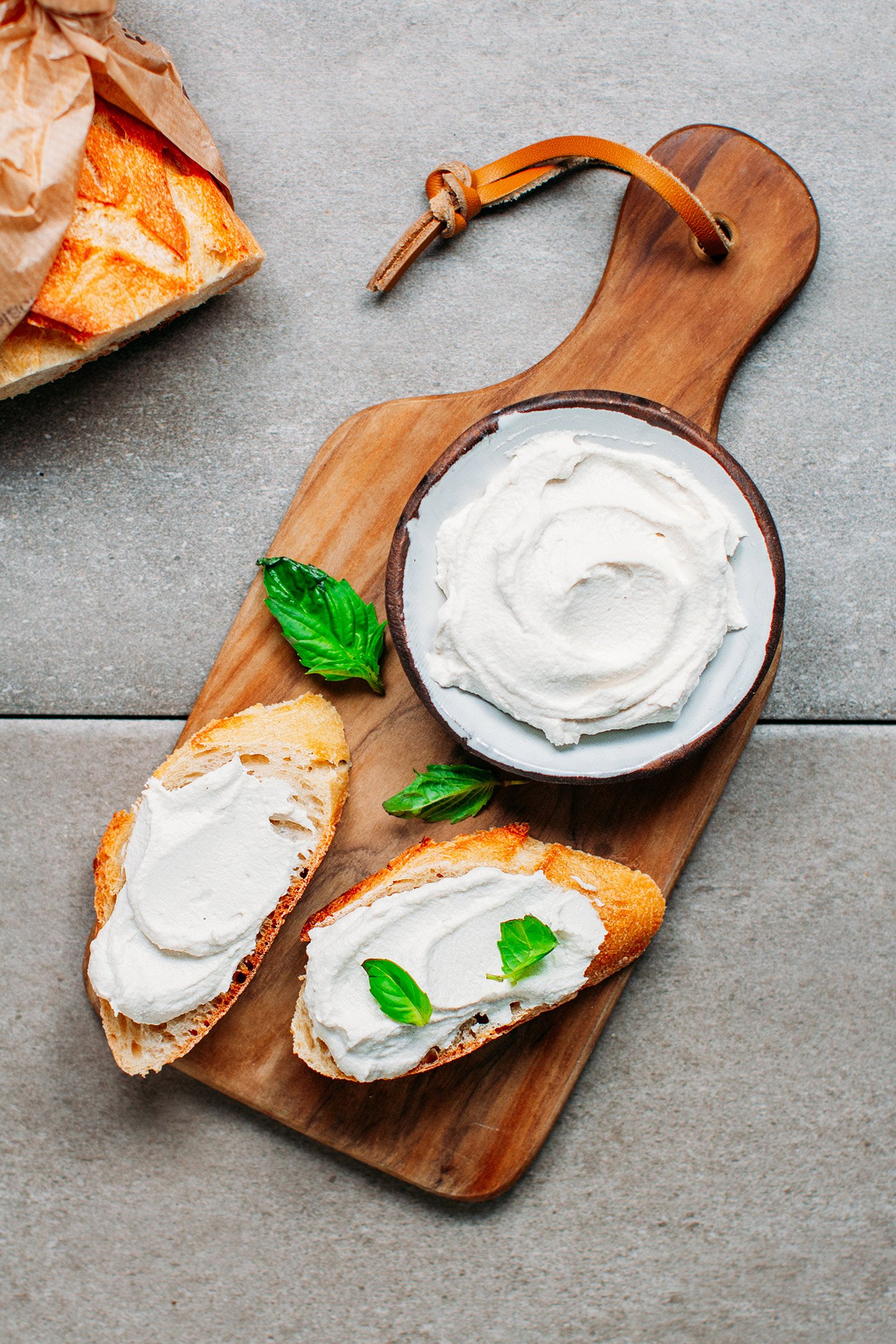 Vegan cream cheese on bread slices.
